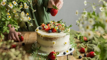 a cake decorated with berries and flowers